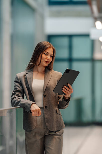 istock Young businesswoman using digital tablet in modern office building 2215784020