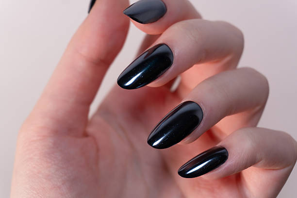 istock Light and refined black manicure on a white background — the contrast enhances the perception of shape and clarity of the polish. 2215784814