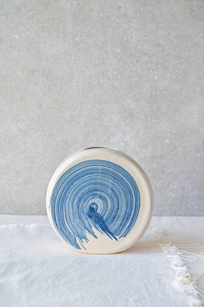 white ceramic vase with a blue swirl