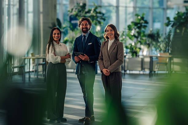 istock Business team smiling at camera in modern office building lobby 2215787910