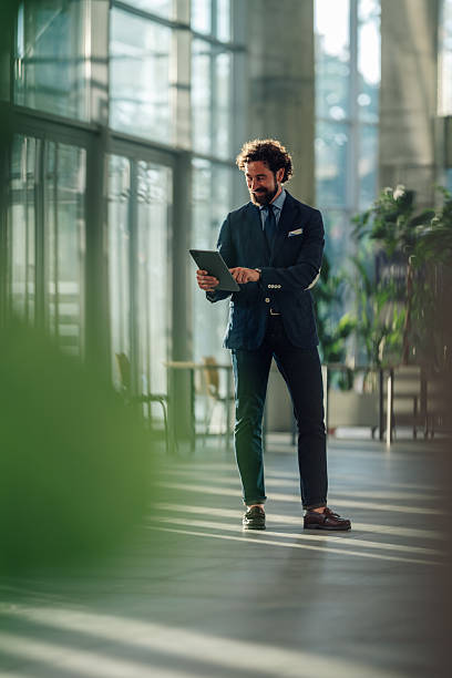 istock Businessman using digital tablet in modern office building 2215787920