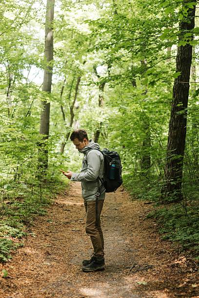 istock A Man checking phone during a walk outdoors 2215789591