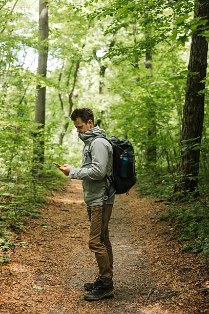 istock A Man checking phone during a walk outdoors 2215790161