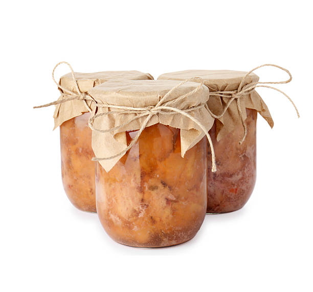 istock Canned meat in glass jars isolated on white 2215790504