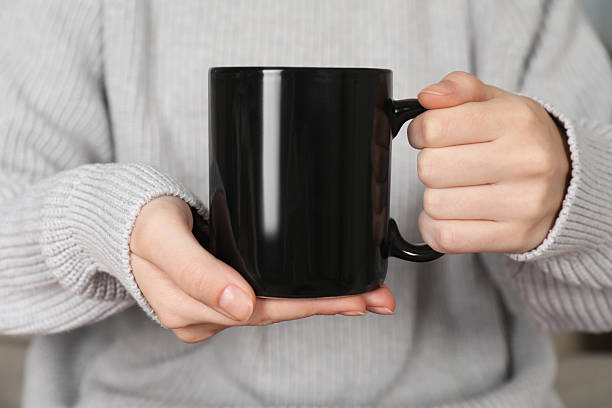istock Woman with black ceramic cup, closeup. Mockup for design 2215790615