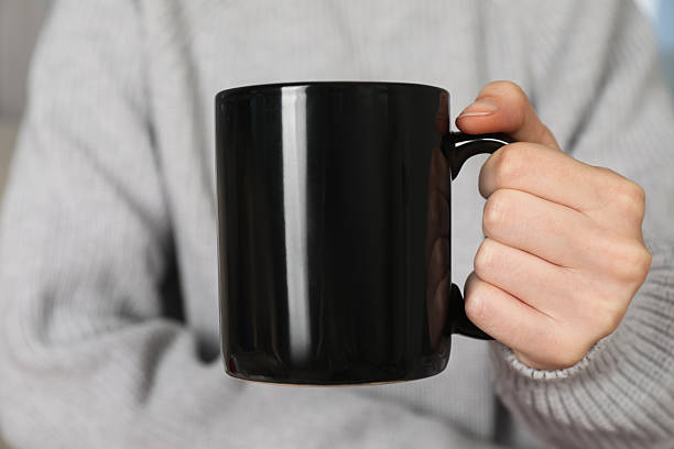 istock Woman with black ceramic cup, closeup. Mockup for design 2215790617