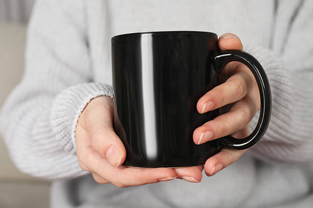 istock Woman with black ceramic cup, closeup. Mockup for design 2215790620