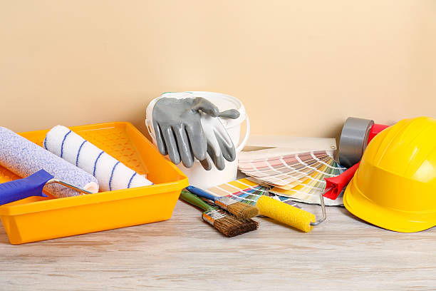 istock Different painter's tools on light wooden table. Decorating and design 2215790669