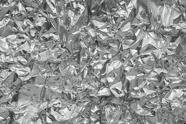 istock Shiny metal silver gray foil leaf crumpled texture background 2215794556