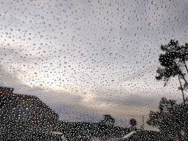 Raindrops on a window, abstracting the outside world. Evokes moodiness, introspection, or a change in perspective. Great for weather, emotion, or reflection themes.