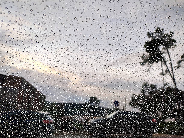 istock Raindrops on glass, obscuring a softfocus landscape. Evokes introspection, isolation, or weather. Use for blogs, articles, or atmospheric design projects. 2215795051