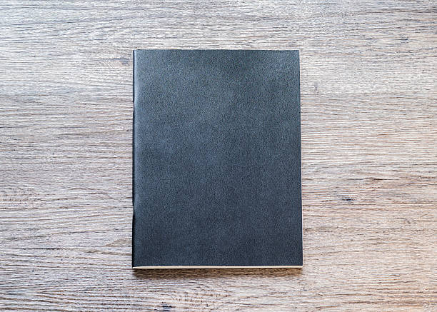 istock Book mockup blank black A4 leather cover for magazine, booklet, brochure, menu, diary mock-up design template on wooden table background 2215795537