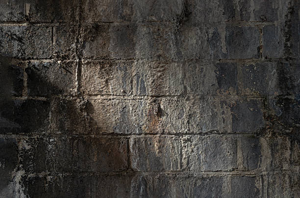 istock An old stained brick wall background with traces of time. 2215795859