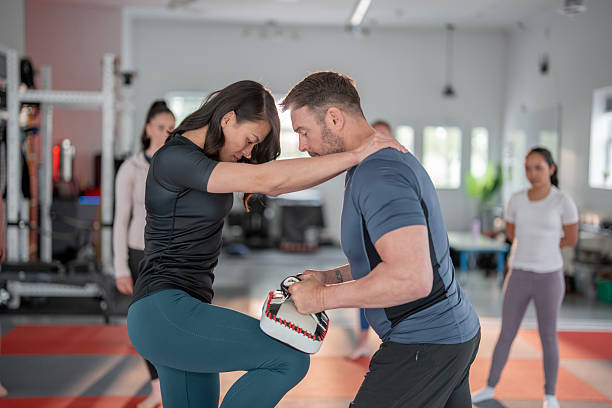 istock Women's Self-Defense Class Featuring Martial Arts Techniques and Guidance 2215798452