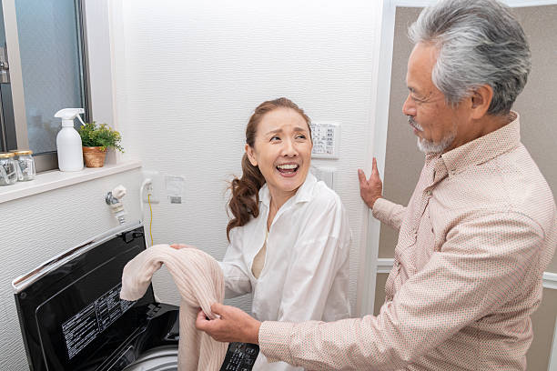 portrait of asian senior age couple doing the laundry