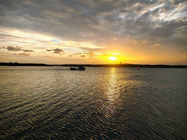 istock Sunset light reflected on the river water. Dusk. Silhouette. 2215809194
