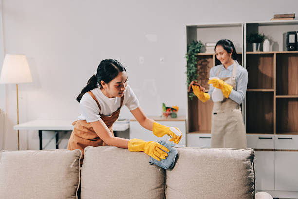 istock Female janitor with vacuum cleaner in room 2215811108