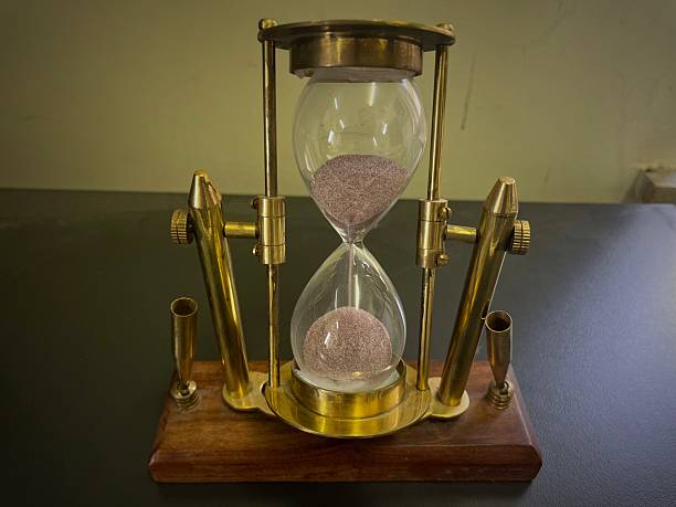 istock Vintage Brass Hourglass on Wooden Base 2215814590