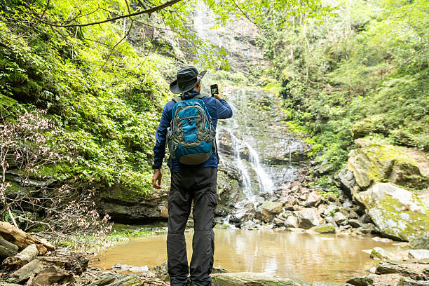 istock Man hiking at waterfalls and streams 2215815883