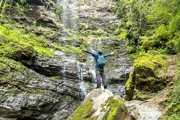 istock Man hiking at waterfalls and streams 2215816014