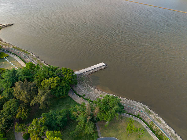 Aerial view of a barge passing a dam on a navigable river.