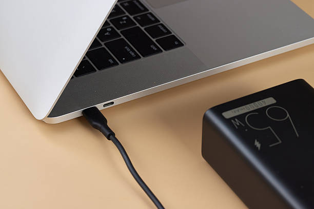 istock Charging laptop with power bank on beige background 2215823024