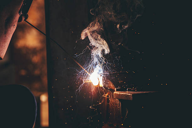 istock Mechanic Men hands use grinder Welding Hot flame metal work cutting fire iron workshop. Repairman Welder Locksmith use machine cut metal. Construction Worker hand Welding machinery iron metal grinder 2215823349