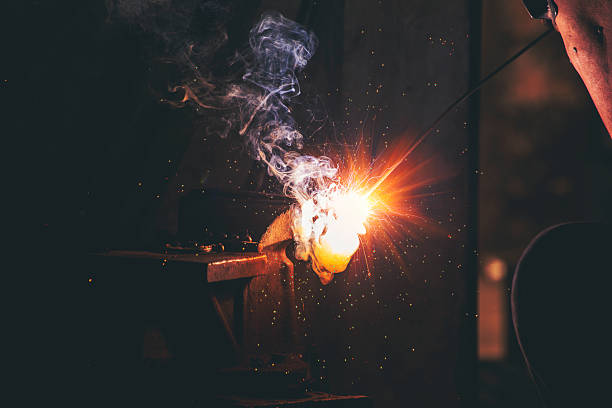 istock Mechanic Men hands use grinder Welding Hot flame metal work cutting fire iron workshop. Repairman Welder Locksmith use machine cut metal. Construction Worker hand Welding machinery iron metal grinder 2215823355