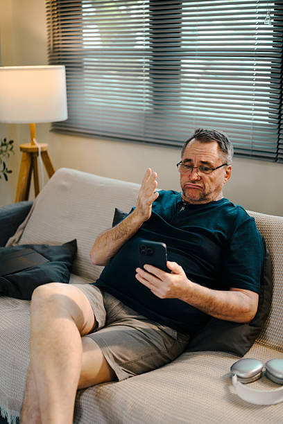 istock Elderly man having video call or checking messages on his smartphone 2215823698