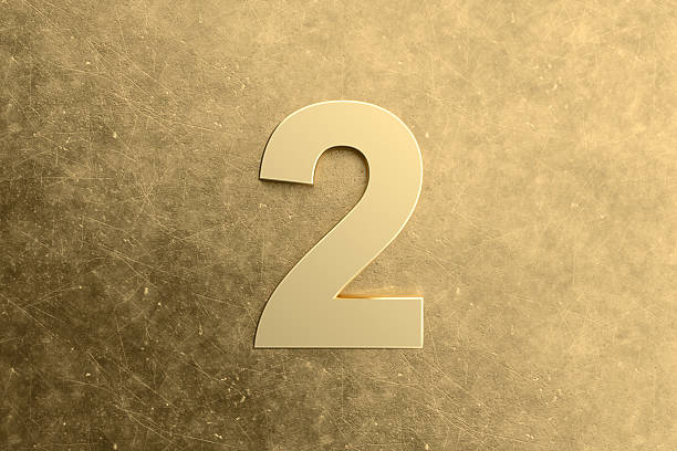 istock Golden number two standing on golden scratched metal surface 2215823874