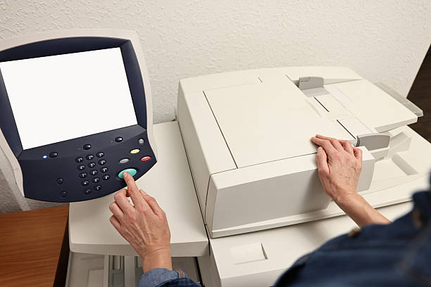 Woman using modern printer indoors, closeup. Printing house