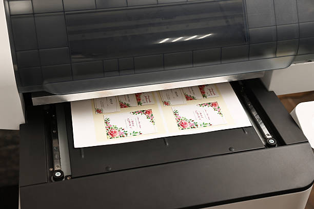 istock Modern printer with printed wedding invitation cards indoors, closeup. Printing house 2215824036