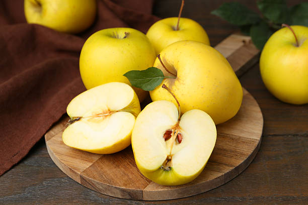 istock Fresh ripe yellow apples on wooden table, closeup 2215824891
