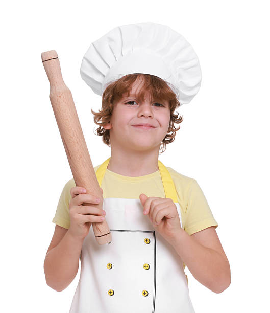 istock Little boy with rolling pin pretending to be chef on white background. Dreaming about future profession 2215825080