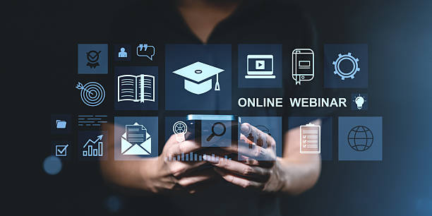 istock Online education webinar interface with digital icons on dark background. 2215827760
