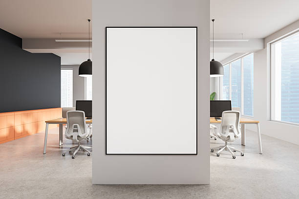 istock Poster mockup on a pillar in a modern open office interior with large windows, natural light, and minimalist furniture. 3D Rendering 2215828265
