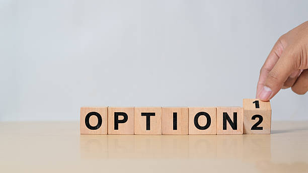 istock Option 1 or option 2. Hand turns a dice and changes the number 1 to 2 2215828324