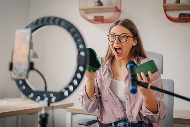 istock Influencer showing products while recording a video review at home 2215829296