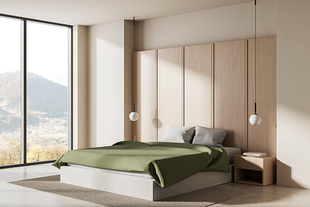 istock Modern minimalist bedroom interior with green bedding, large window view of mountains, light wood panel walls, pendant lights, cozy and serene atmosphere. 3D Rendering 2215829303