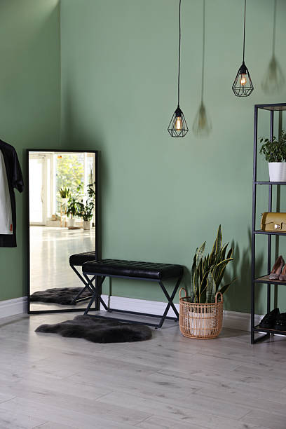 istock Stylish hallway interior with mirror and shelving unit 2215831406
