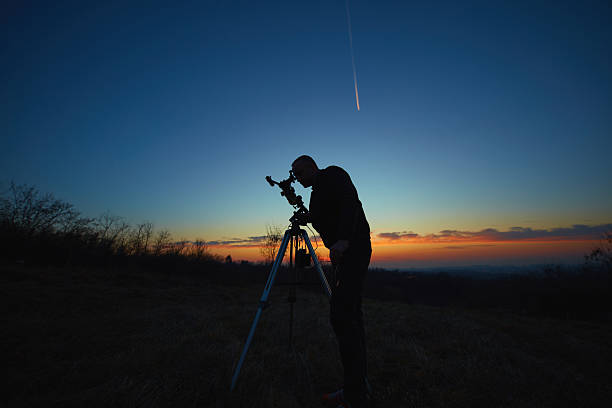 istock Amateur astronomer using telescope for watching stars, Moon, planets and other celestial objects from a field in nature. 2215832409