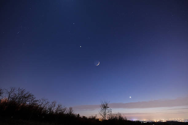 istock Crescent young Moon with stars, planets and countryside silhouettes. 2215832584