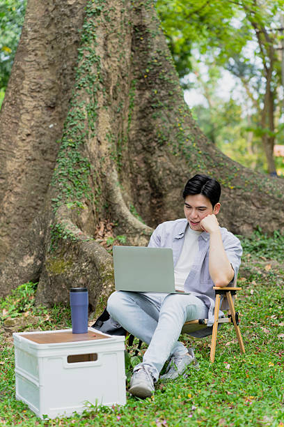 Man Working on Laptop in Outdoor Natural Setting With Relaxed Ambiance