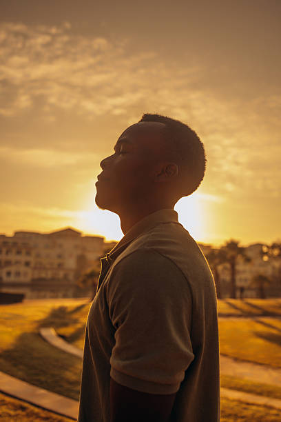 Silhouette of a Man Meditating at Sunrise Outdoors in a Peaceful Setting