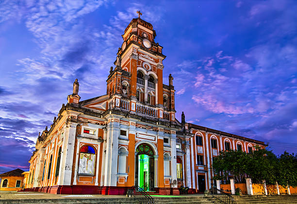 Granada, Nicaragua - November 29, 2011: People walk on Plaza de la Catedral, besides the landmark Cathedral of Granada in Granada, Nicaragua.