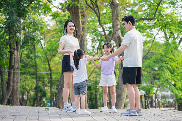 istock Happy Family Playing Together in a Park on a Sunny Day 2215836312