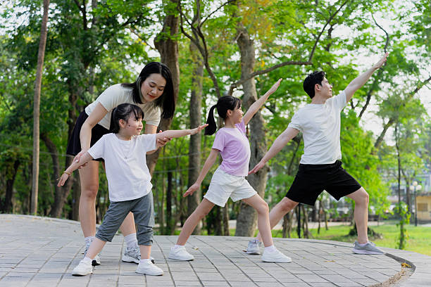 istock Happy Family Exercising Outdoors Together in a Park on a Sunny Day 2215836340