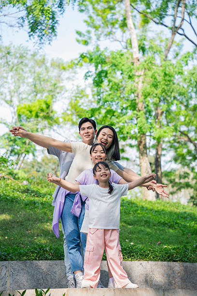 istock Happy Family Posing Together Outdoors in a Green Park Setting 2215836449