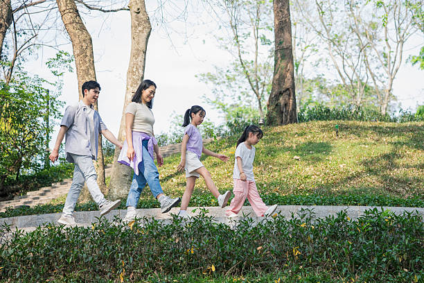 istock Happy Family Walking Outdoors in a Lush Green Forest Park 2215836501