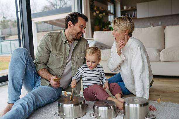 istock Parents and toddler son playing drums on kitchen pots 2215836960